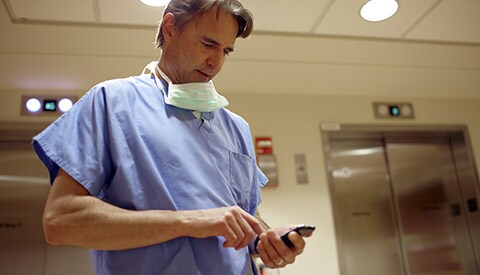 A clinician viewing patient records on a mobile device